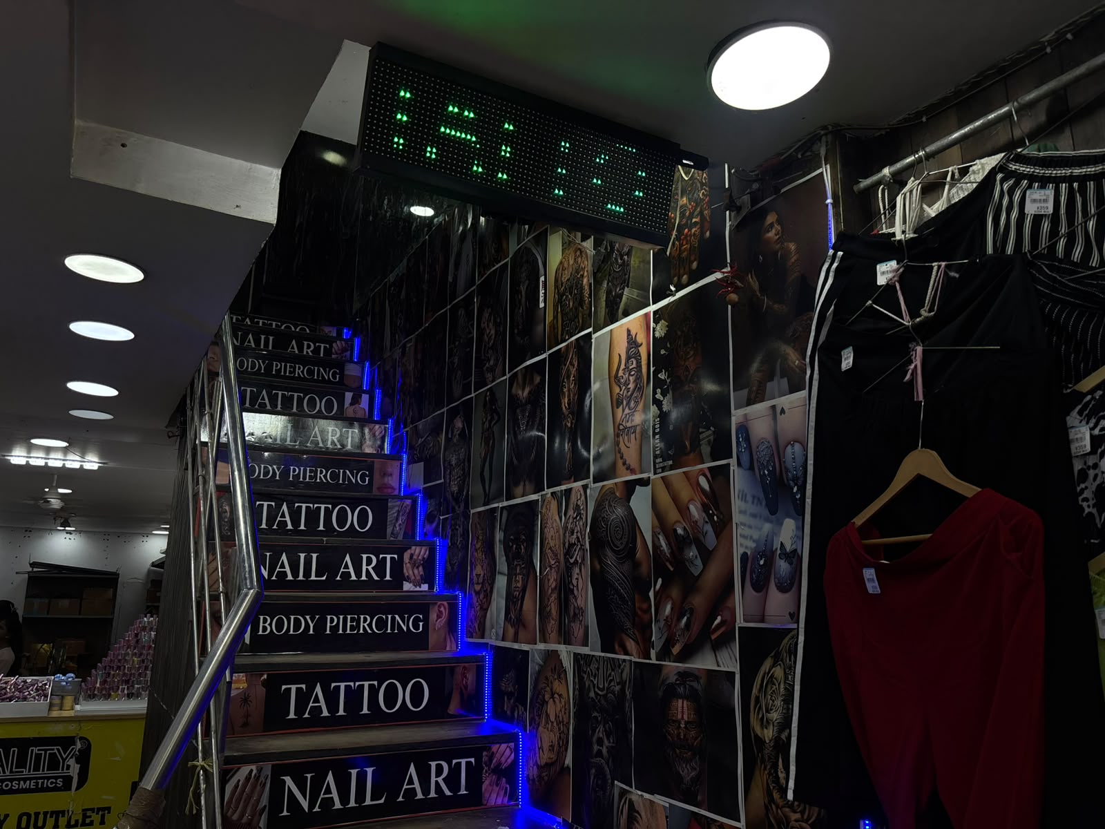 Staircase entrance to Sid Ink Tattoo signposted for tattoo, nail art and body piercing in Sarojini Nagar Market