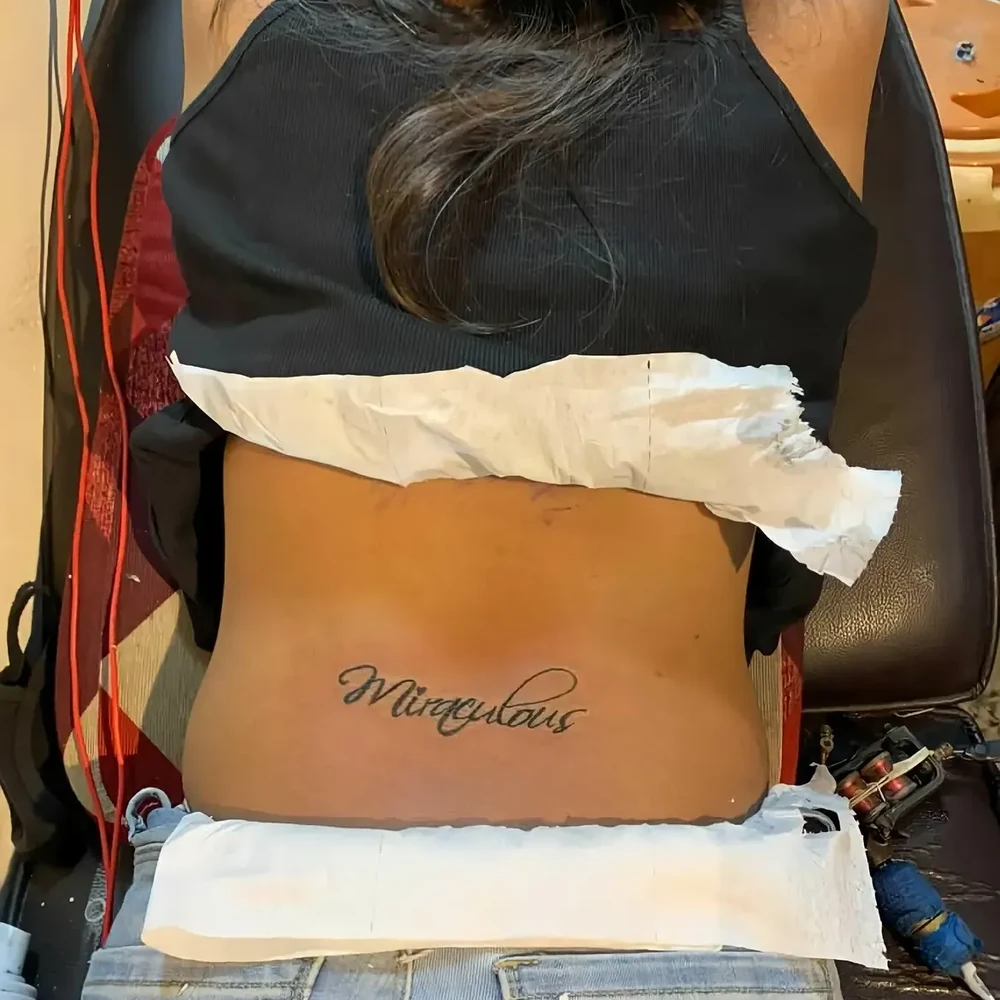 Handwritten style black ink lettering tattoo by Sid Ink Tattoo in Sarojini Nagar Market